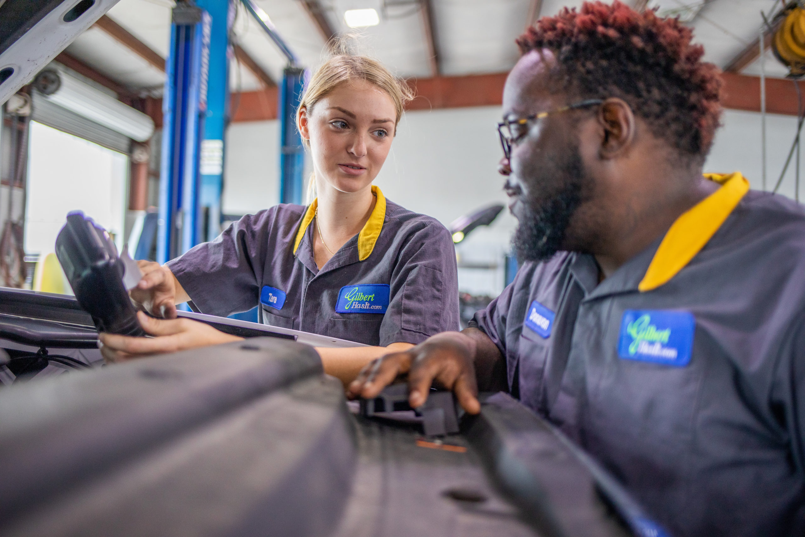Chevy Service Tech Tara Hunt collaborates with co-worker at Gilbert Chevrolet in Okeechobee
